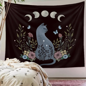 Detailed view of black cat tapestry with moon phases and floral art on bedroom wall