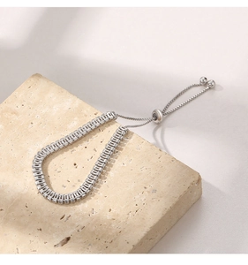 Detailed macro view of silver zircon bracelet with adjustable sliding box chain