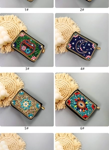 Detail of bohemian beaded card wallets with handmade floral and moon patterns