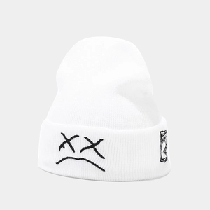 Macro detail of the white knit beanie featuring minimalist black cry face embroidery