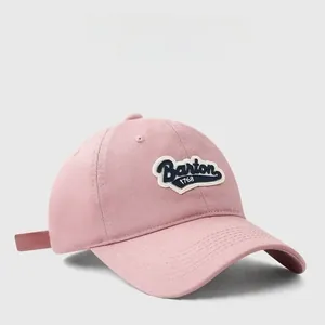 Detailed close-up of pink cotton baseball cap with vintage Barton 1768 embroidery