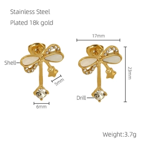 Detail of 18K gold plated stainless steel bow earrings with zircon and mother of pearl