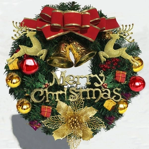 Detail of Christmas wreath with golden Merry Christmas sign, reindeer, and red bows