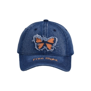 Detail of butterfly denim cap with Free Flight embroidery and frayed patch on curved brim