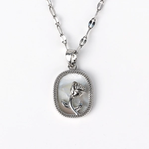 Macro view of oval shell pendant featuring a silver rose relief and zircon border