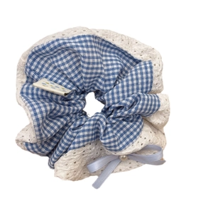 Blue plaid scrunchie with lace trim, satin bow and pearl accent on white background
