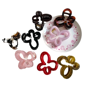 Set of eight assorted butterfly and flower hair claws in multiple colors for women