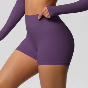 Detail of high-waist purple yoga shorts and long sleeve top in seamless knit fabric