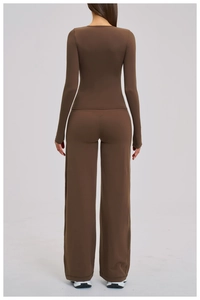 Detail view of chocolate yoga set featuring high-waisted wide-leg pants and long-sleeve top