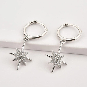 Detailed close-up of S925 sterling silver starburst earrings with sparkling cubic zirconia
