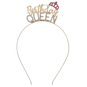Close-up of golden Birthday QUEEN headband with sparkling white and pink rhinestones