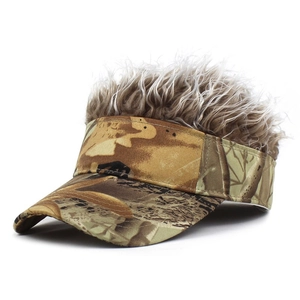 Macro shot of jungle camouflage baseball cap with light brown fluffy synthetic hair