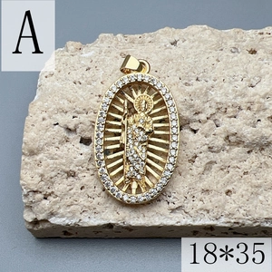 Macro detail of gold-plated oval Jesus pendant with white zircon inlay on stone