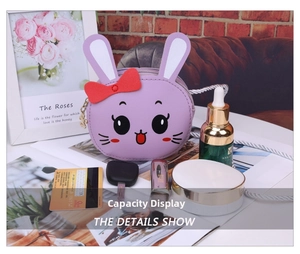 Detail view showing interior capacity of a purple rabbit toddler purse with small essentials