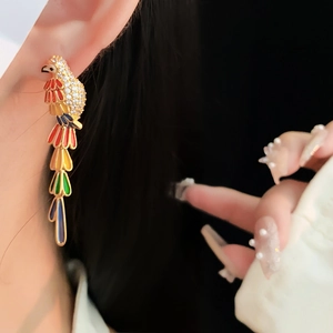 Detail of vintage parrot earring with colorful enamel finish and sparkling crystal accents