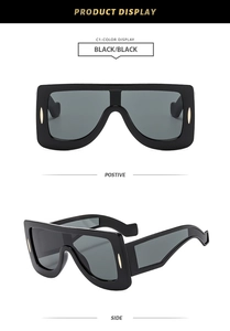 Detail view of large frame futuristic sunglasses in gloss black with metal accents