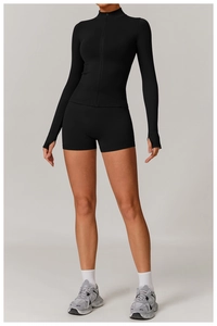 Detail of black sports set featuring long sleeve thumb hole top and high waist shorts