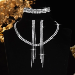 Detailed view of rhinestone jewelry set with tassel necklace, bracelet and earrings