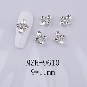 Detail of 9x11mm cross flower nail charms with silver metal base and clear rhinestones
