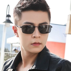 Close-up of retro square black lenses with minimalist metal frames on male model