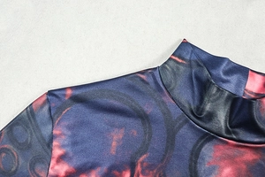 Detailed view of high neck print dress showing blue and orange abstract pattern and seams