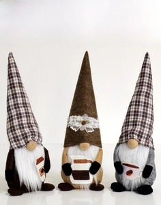 Detailed view of three coffee-themed Christmas gnomes with felt hats and wooden noses