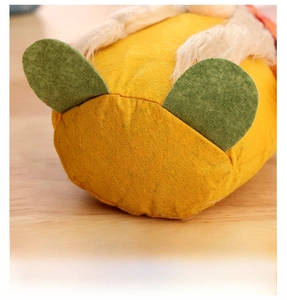 Detailed bottom view of harvest gnome doll with green felt feet and soft yellow fabric