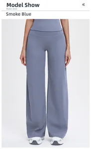 Detail of smoky grey blue high-waisted wide leg sports pants with premium knit texture