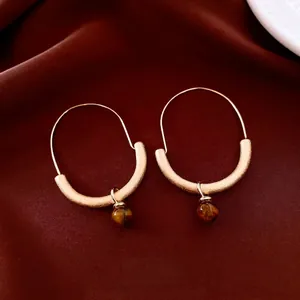 Vintage gold brushed earrings featuring natural tiger eye stone circular pendants