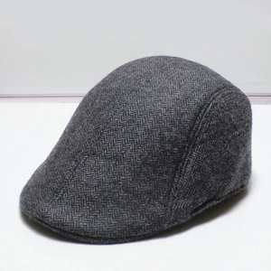 Dark grey herringbone flat cap for men with premium wool-like texture and curved brim