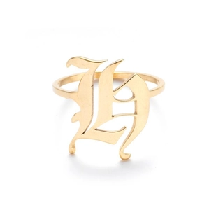 Macro shot of polished gold-finished ring featuring Gothic Old English letter H detail