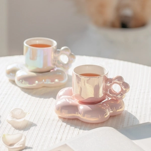 Close-up of pearlized sunflower ceramic coffee cups with creative cloud-shaped saucers