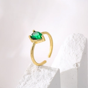 Minimalist heart-shaped green zircon open ring with a gold-plated rope band on white stone
