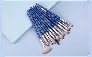 Detail of 13 professional eye makeup brushes with blue matte handles and gradient bristles