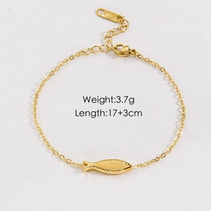 Macro view of gold stainless steel fish pendant with scale texture and lobster clasp detail