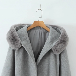 Women's grey hooded woolen cloak coat with faux fur collar displayed on a hanger