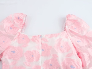 Detail of floral jacquard dress featuring square neckline and invisible zipper closure