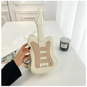 Detail of guitar shaped crossbody bag with metallic rivets and white-brown contrast stitching