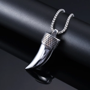 Polished stainless steel wolf tooth pendant necklace on a premium black reflective stand
