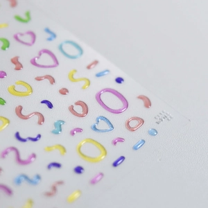 Macro shot of 3D embossed jelly nail art stickers with colorful macaron geometric shapes