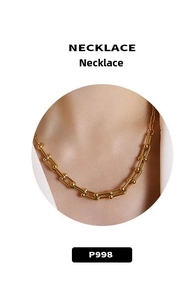 Macro shot of 18K gold-plated U-link chain necklace with ball details for women