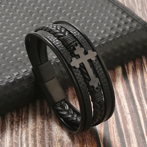 Detail of black multi-layer leather bracelet for men with metal cross and magnetic clasp