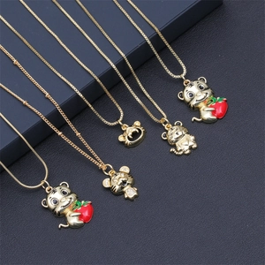 Golden tiger pendant necklaces with red heart and enamel details on textured background