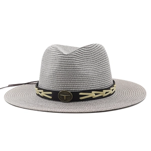 Detail of grey-white Panama straw hat with black band and vintage bull head metal buckle
