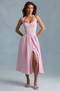Detail of pink halter neck dress featuring front buttons and side leg slit design