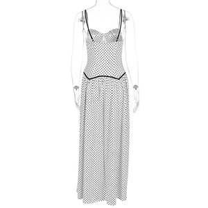Detail of white polka dot lace dress with adjustable straps and slim fit design