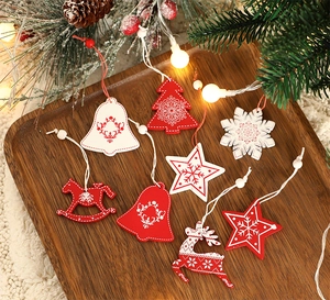 Detailed view of red and white wooden Christmas ornaments with festive Nordic patterns