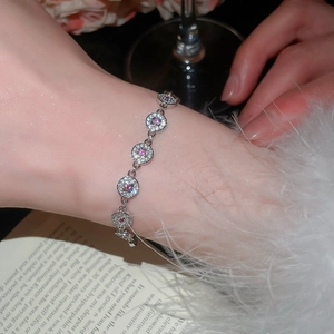 Detail of elegant silver bracelet with sparkling pink and clear cubic zirconia on wrist.
