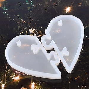 Translucent heart puzzle silicone mold for resin jewelry craft on festive background