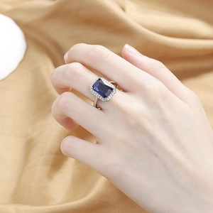 Vintage rectangular blue crystal ring with pavé stones on a polished silver band